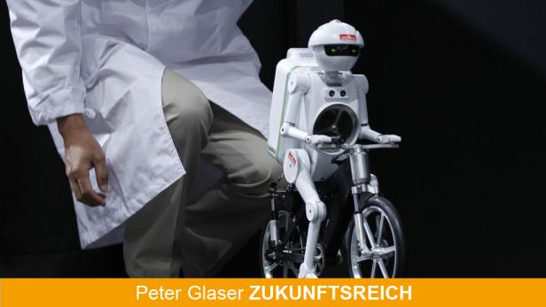 An employee of Japans Murata Manufacturing Co. presents the companys bicycle-riding robot "Murata Seisaku-kun" at CEATEC JAPAN 2011 electronics show in Chiba, east of Tokyo, October 4, 2011. The IT & Electronics comprehensive exhibition goes on till Octob