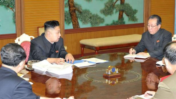 EPAepa03557672 North Korean leader Kim Jong-un (3rd L) presides over a national defense meeting with his top officials in Pyongyang on Jan. 27, 2013, to discuss measures against the latest resolution by the U.N. Security Council that punishes the regime f