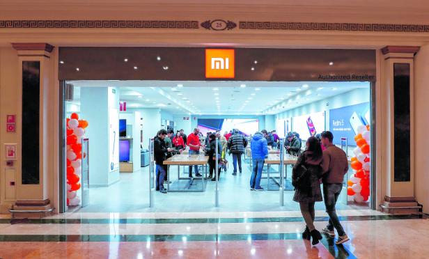 Customers enter a Xiaomi shop in a shopping mall in Barcelona