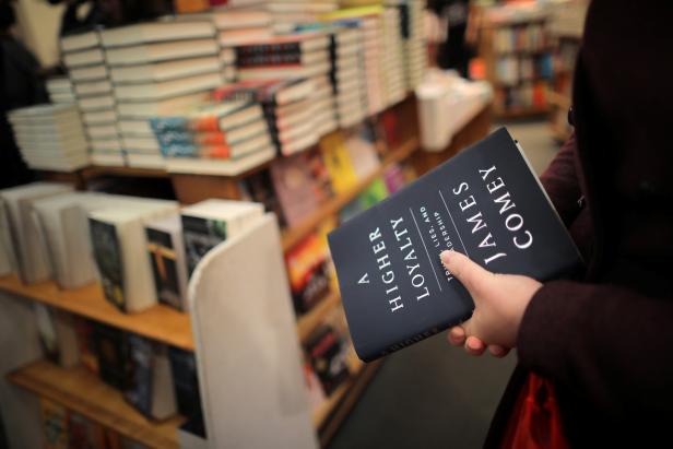 A woman holds a copy of former FBI director James Comey's book "A Higher Loyalty" at Kramerbooks book store in Washington D.C. A woman holds a copy of former FBI director James Comey's book "A Higher Loyalty" at Kramerbooks book store in Washington D.C.