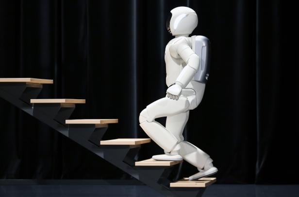 Honda's latest version of the Asimo humanoid robot walks up stairs during a presentation in Zaventem near Brussels