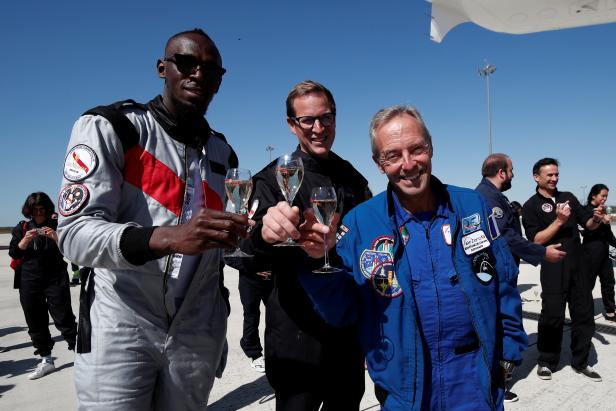 Retired sprinter Usain Bolt, French astronaut Jean-Francois Clervoy, CEO of Novespace, and Quentin Meurisse from Martell Mumm Perrier-Jout after they enjoyed zero gravity conditions during a flight in a specially modified Airbus Zero-G plane above Reims