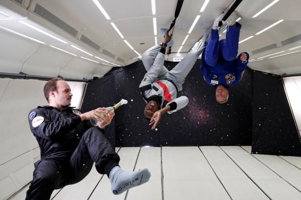 Retired sprinter Usain Bolt and French astronaut Jean-Francois Clervoy enjoy zero gravity conditions during a flight in a specially modified plane above Reims