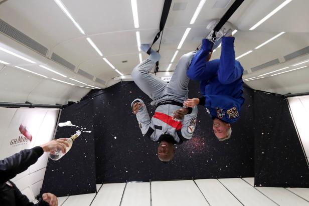 Retired sprinter Usain Bolt and French astronaut Jean-Francois Clervoy enjoy zero gravity conditions during a flight in a specially modified plane above Reims