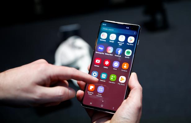 A journalist uses the new Samsung Galaxy S10 smartphone at a press event in London