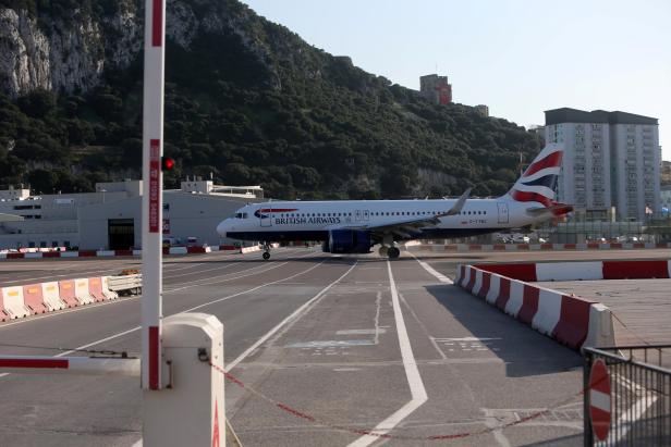 A British Airways aircraft lands at Gibraltar International airport in front of the Rock of the British Colony of Gibraltar