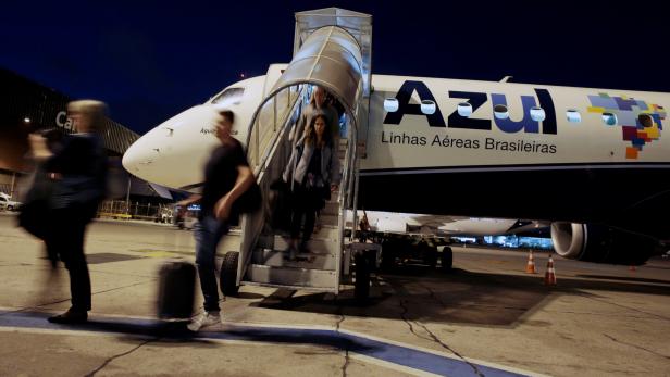 Passengers disembark from Azul Brazilian Airlines plane at International Airport in Guarulhos