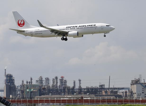 FILE PHOTO: Japan Airlines' airplane flies near Haneda Airport in Tokyo