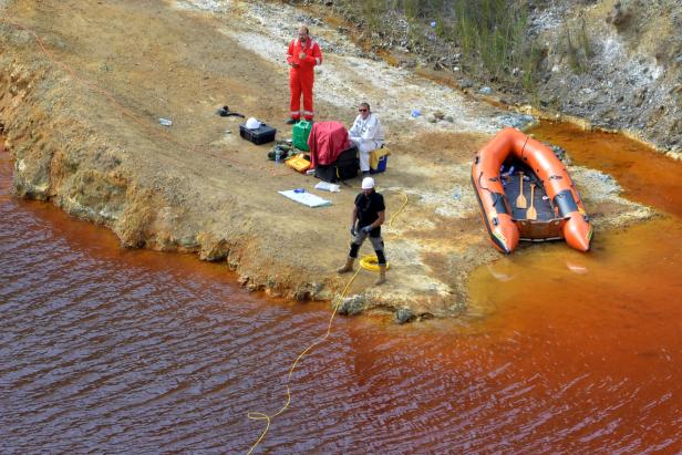 Forensics officers search Kokkinopezoula lake, also known as "red lake", for possible bodies of victims of a suspected serial killer near the village of Mitsero