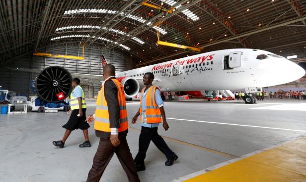 FILE PHOTO: Workers walk past a Kenya Airways Boeing Dreamliner 787-8 inside a hangar at their headquarters in Nairobi