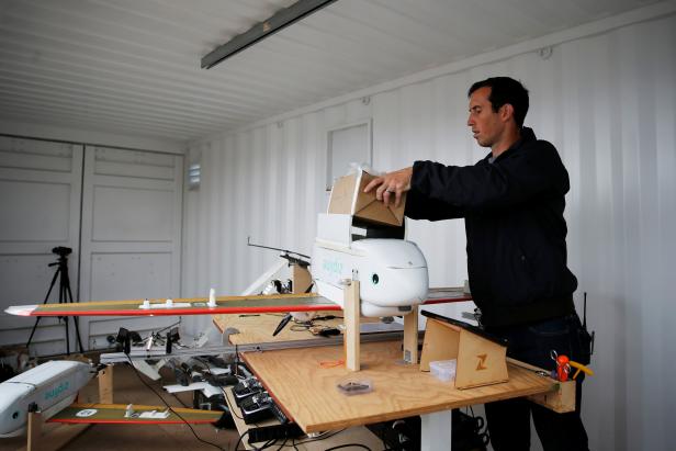 Eric Watson loads a payload into a Zipline aerial delivery drone during a flight demonstration at an undisclosed location in the San Francisco Bay Area, California