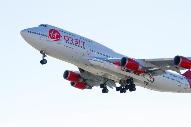 Richard Branson's Virgin Orbit, with a rocket underneath the wing of a modified Boeing 747 jetliner, takes off to for a key drop test of its high-altitude launch system for satellites from Mojave, California