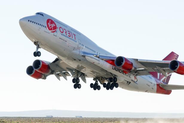 Richard Branson's Virgin Orbit, with a rocket underneath the wing of a modified Boeing 747 jetliner, takes off to for a key drop test of its high-altitude launch system for satellites from Mojave, California