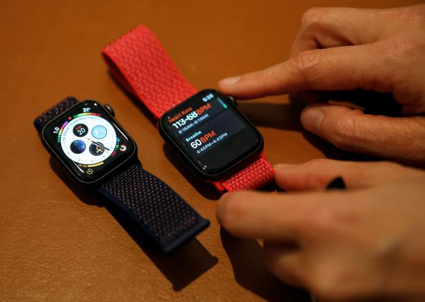 An Apple employee shows the features of the new Apple Watch Series 4 at the Apple Store in Singapore