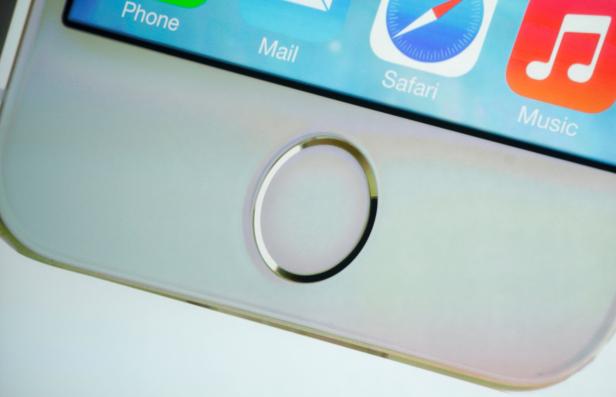 FILE PHOTO: The home button which doubles as a fingerprint sensor is seen on an image of the new iPhone 5S at Apple Inc's media event in Cupertino