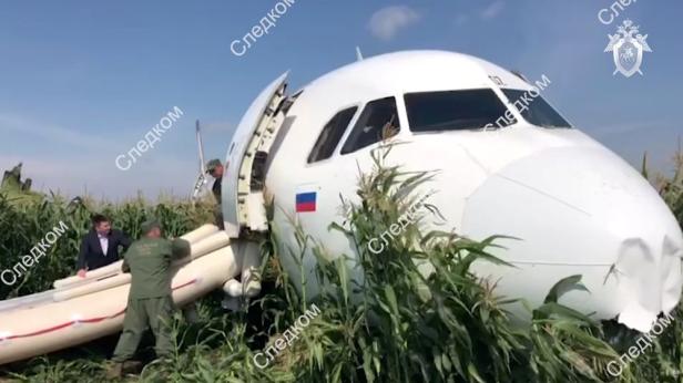 A still image shows a passenger plane following an emergency landing near Moscow