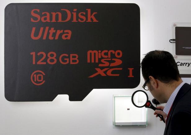 File photo of a visitor looking at a SanDisk microSD card at the Mobile World Congress in Barcelona