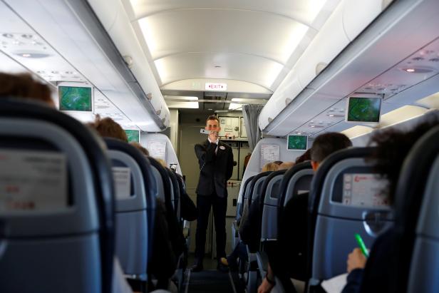 A flight attendant gives safety instructions to passengers aboard a Laudamotion Airbus A320 plane in Duesseldorf