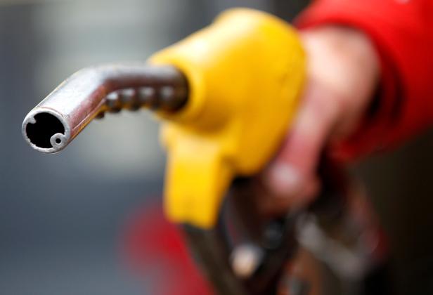 FILE PHOTO: An attendant prepares to refuel a car at a petrol station in Rome