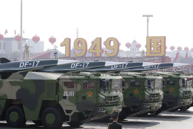 Military vehicles carrying hypersonic missiles DF-17 travel past Tiananmen Square during the military parade marking the 70th founding anniversary of People's Republic of China