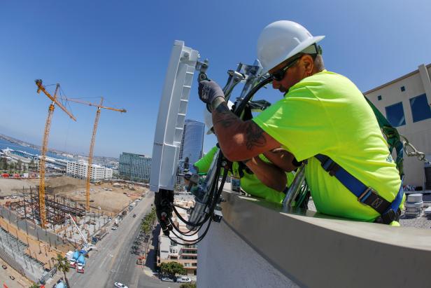 FILE PHOTO: Telecoms workers install a 5G antenna system for AT&T in downtown San Diego