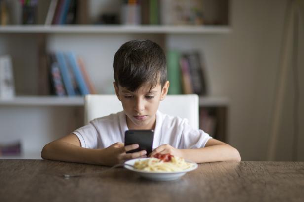 Boy eating spaghetti