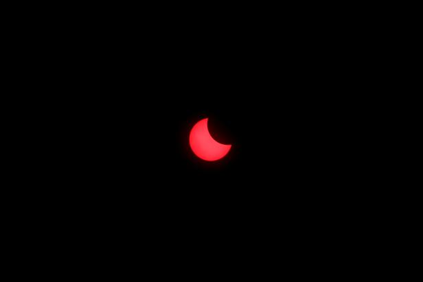 An annular solar eclipse is observed with the use of a solar filter in Siak, Riau province