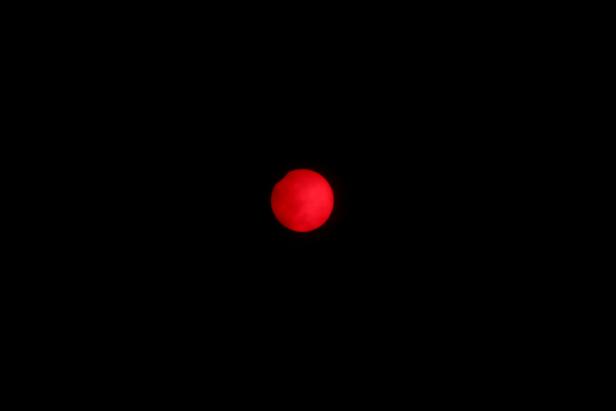 An annular solar eclipse is observed with the use of a solar filter in Siak, Riau province