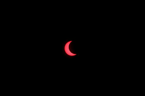 An annular solar eclipse is observed with the use of a solar filter in Siak, Riau province