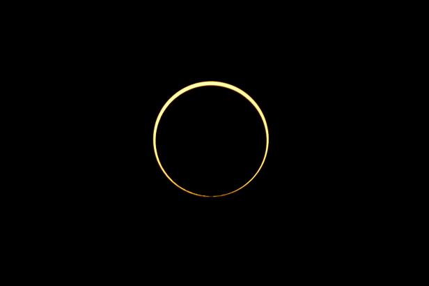 The moon passes between the sun and the earth during an annular solar eclipse in Singapore