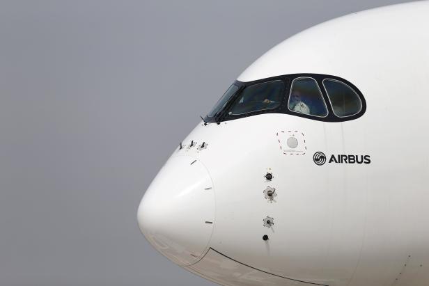 A pilot sits in the cockpit of an Airbus A350 XWB aircraft  ahead of the  International Air and Space Fair at Santiago