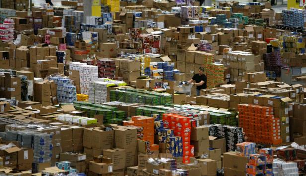 A worker sorts packages at the Amazon warehouse in Leipzig