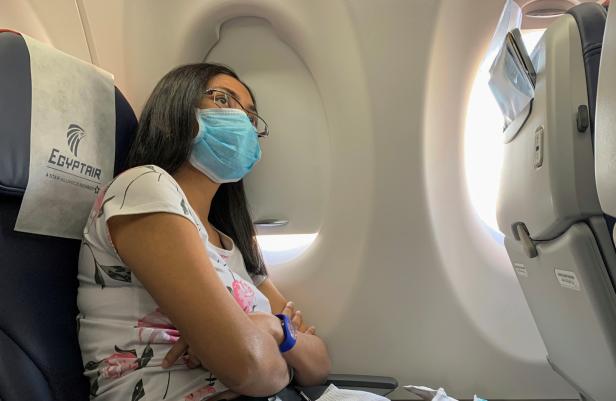 A passenger wears a protective mask on an Egyptair flight from Luxor to Cairo, following the outbreak of the coronavirus disease (COVID-19), in Egypt