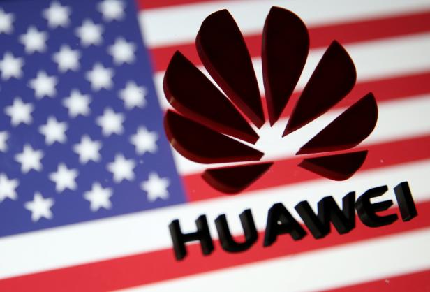 FILE PHOTO: A 3D printed Huawei logo is placed on glass above displayed US flag in this illustration