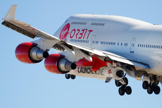 Richard Branson's Virgin Orbit, with a rocket underneath the wing of a modified Boeing 747 jetliner, takes off to for a key drop test of its high-altitude launch system for satellites from Mojave, California