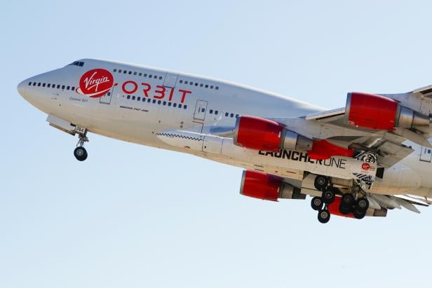 Richard Branson's Virgin Orbit, with a rocket underneath the wing of a modified Boeing 747 jetliner, takes off to for a key drop test of its high-altitude launch system for satellites from Mojave, California