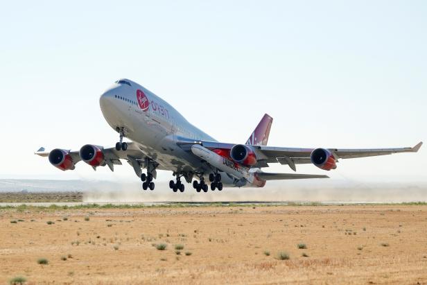 Richard Branson's Virgin Orbit, with a rocket underneath the wing of a modified Boeing 747 jetliner, takes off to for a key drop test of its high-altitude launch system for satellites from Mojave, California