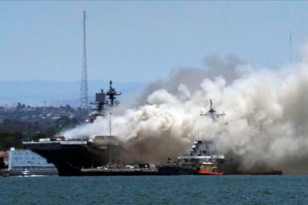 Smoke rises from a fire on board the U.S. Navy amphibious assault ship USS Bonhomme Richard at Naval Base San Diego