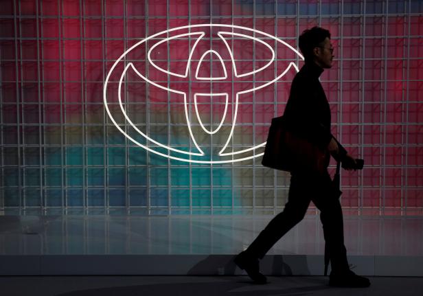 FILE PHOTO: A man walks past a Toyota logo at the Tokyo Motor Show