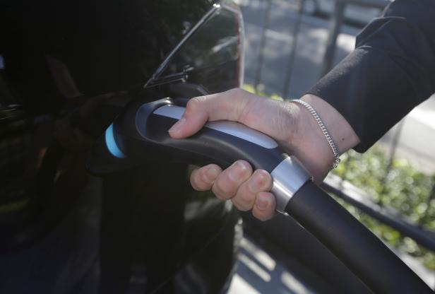 A Tesla Model S electric car is charged by a supercharger at a Tesla electric car dealership in Sydney