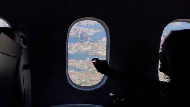 A passenger looks out of a plane window during Qantas Great Southern Land scenic flight in Australia