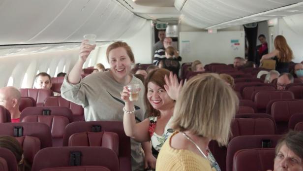 Passengers cheer during Qantas Great Southern Land scenic flight in Australia