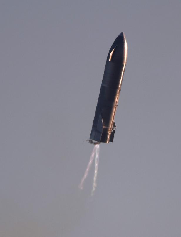 SpaceX's first super heavy-lift Starship SN8 rocket prepares to land after it launched from their facility on a test flight in Boca Chica, Texas