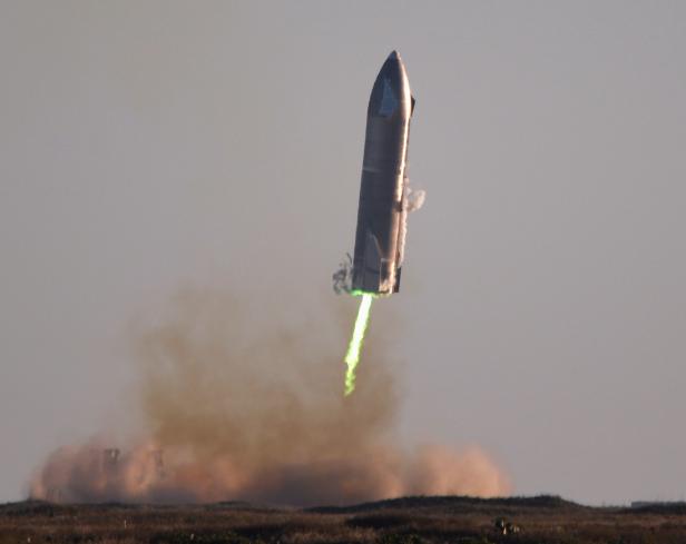 SpaceX's first super heavy-lift Starship SN8 rocket prepares to land after it launched from their facility on a test flight in Boca Chica, Texas