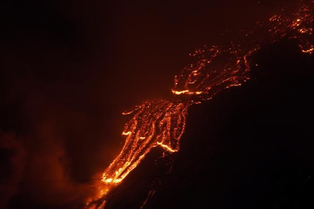 Lava flows from Mount Etna during an eruption, as seen from Fornazzo