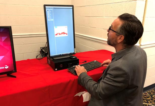 Eric Coomer, Director of Product Strategy for Dominion Voting Systems, demonstrates one of the company's voting machines, in Harrisburg