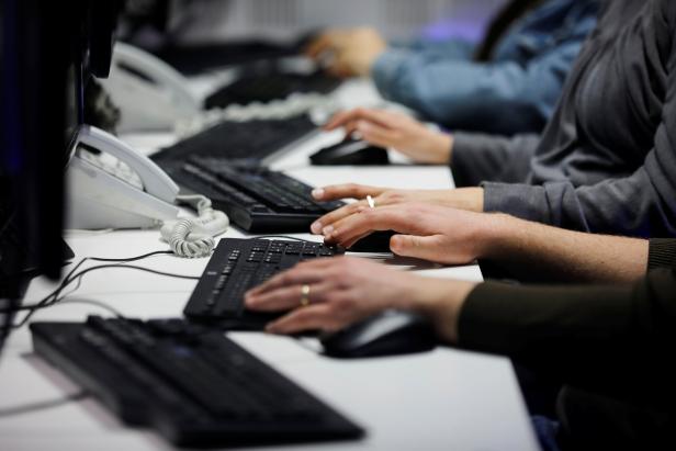 Employees, mostly veterans of military computing units, use keyboards as they work at a cyber hotline facility at Israel's Computer Emergency Response Centre (CERT) in Beersheba, southern Israel