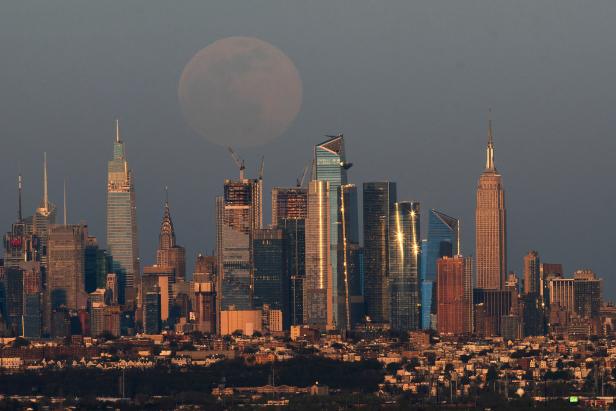 The full moon, known as the "Super Pink Moon", rises over the skyline of New York and Empire State Building, as seen from West Orange, in New Jersey