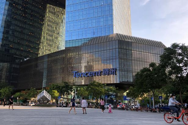 FILE PHOTO: People are seen in front of the Tencent company headquarters in Shenzhen