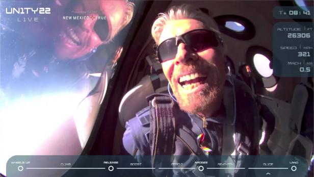 Billionaire Richard Branson reacts on board Virgin Galactic's passenger rocket plane VSS Unity after reaching the edge of space above Spaceport America